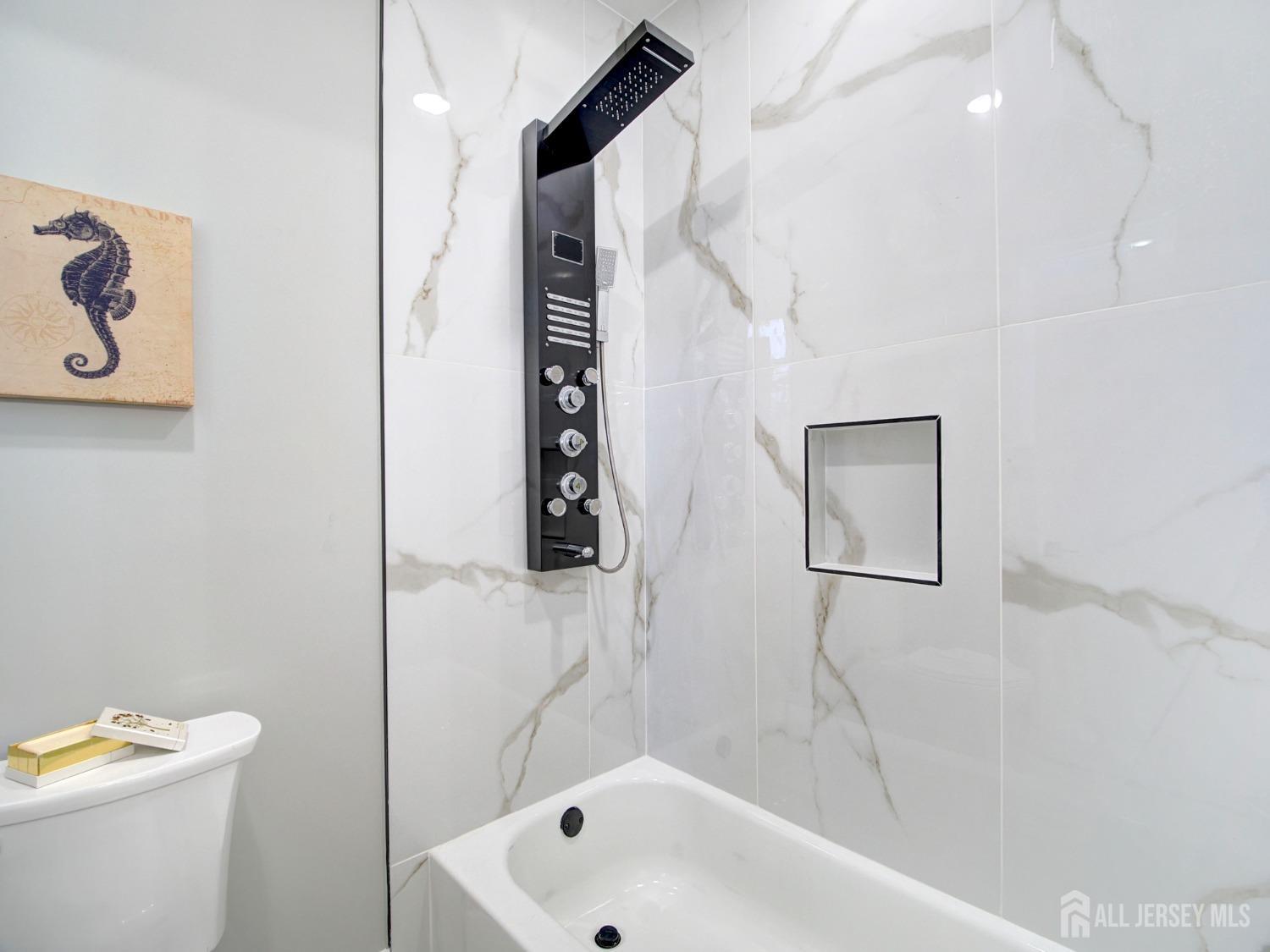 24 Stiles Road Edison, NJ 08817 - Photo 33 of 36 a bathroom with a bathtub and a shower