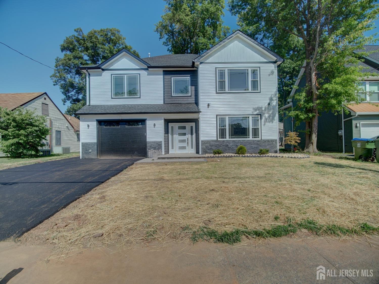 24 Stiles Road Edison, NJ 08817 - Photo 36 of 36 a front view of a house with yard and trees