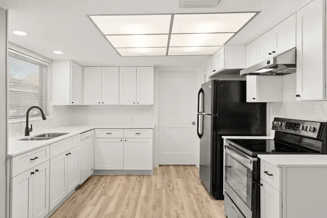 a kitchen with cabinets and stainless steel appliances