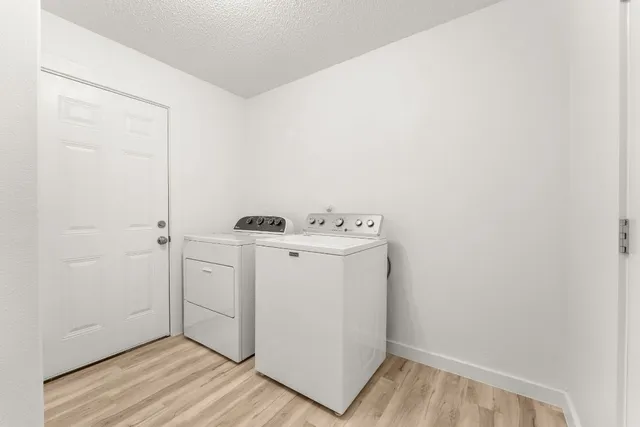 a utility room with cabinets washer and dryer