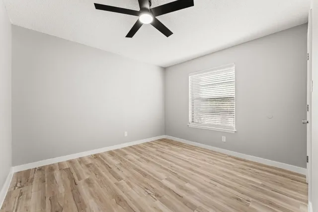 wooden floor in an empty room with a window