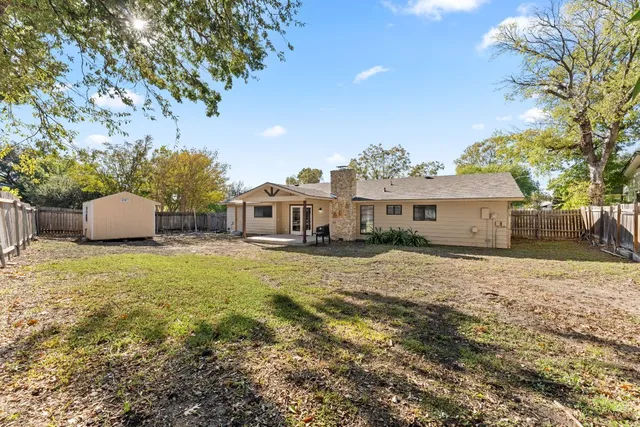 a front view of house with yard and trees