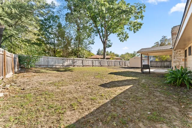 a view of a backyard with large trees