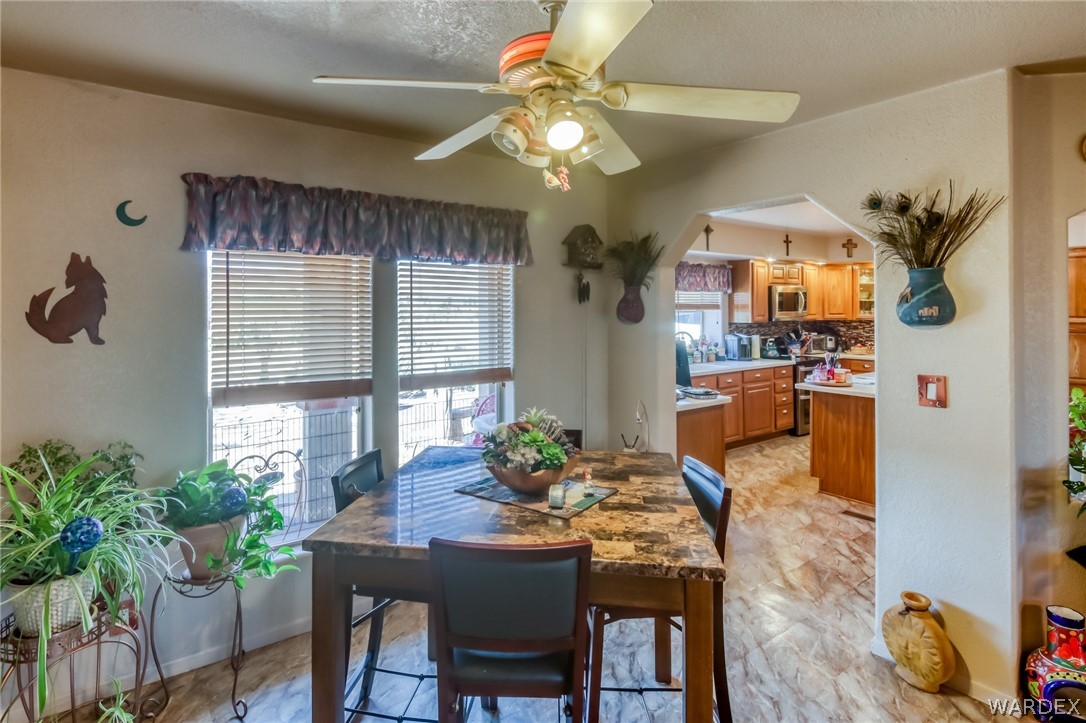 4150 Dragoon Road Golden Valley, AZ 86413 - Photo 16 of 49 a view of a dining room with furniture and a potted plant