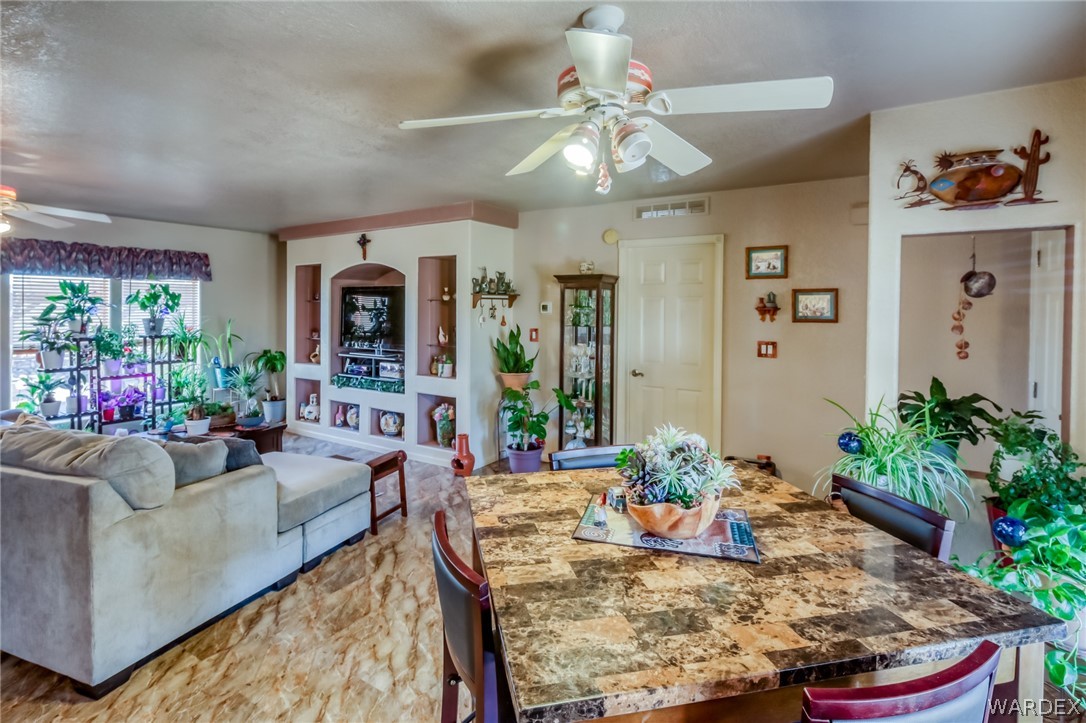 4150 Dragoon Road Golden Valley, AZ 86413 - Photo 18 of 49 a living room with furniture dining table and a potted plant