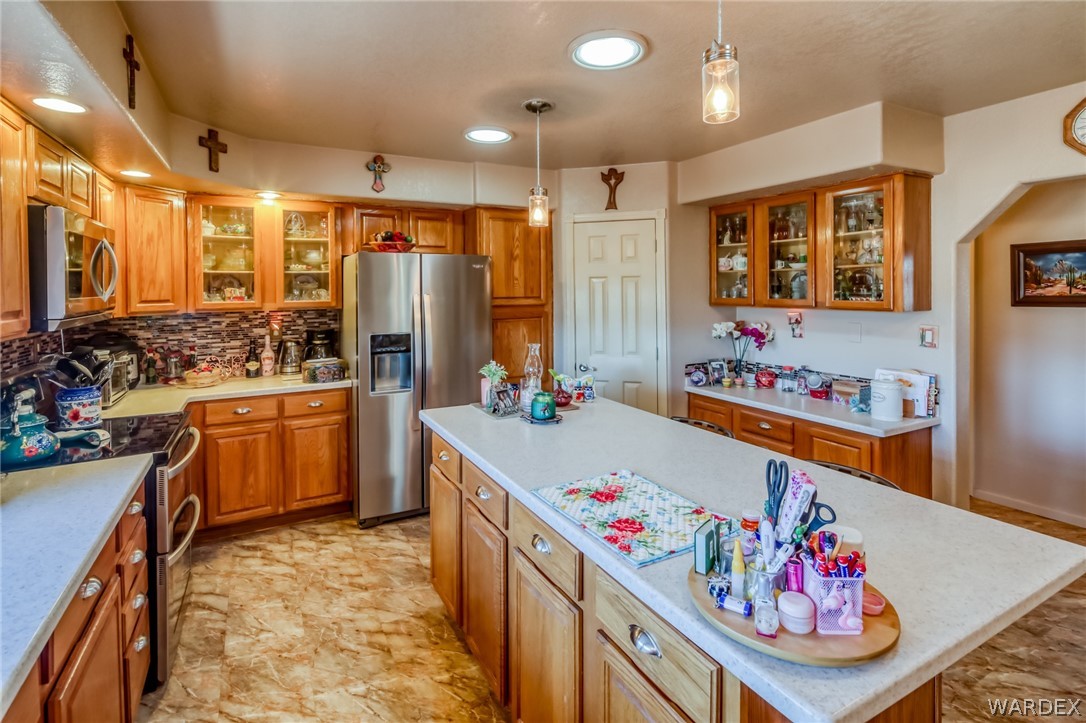 4150 Dragoon Road Golden Valley, AZ 86413 - Photo 21 of 49 a kitchen that has a lot of cabinets a washer and dryer