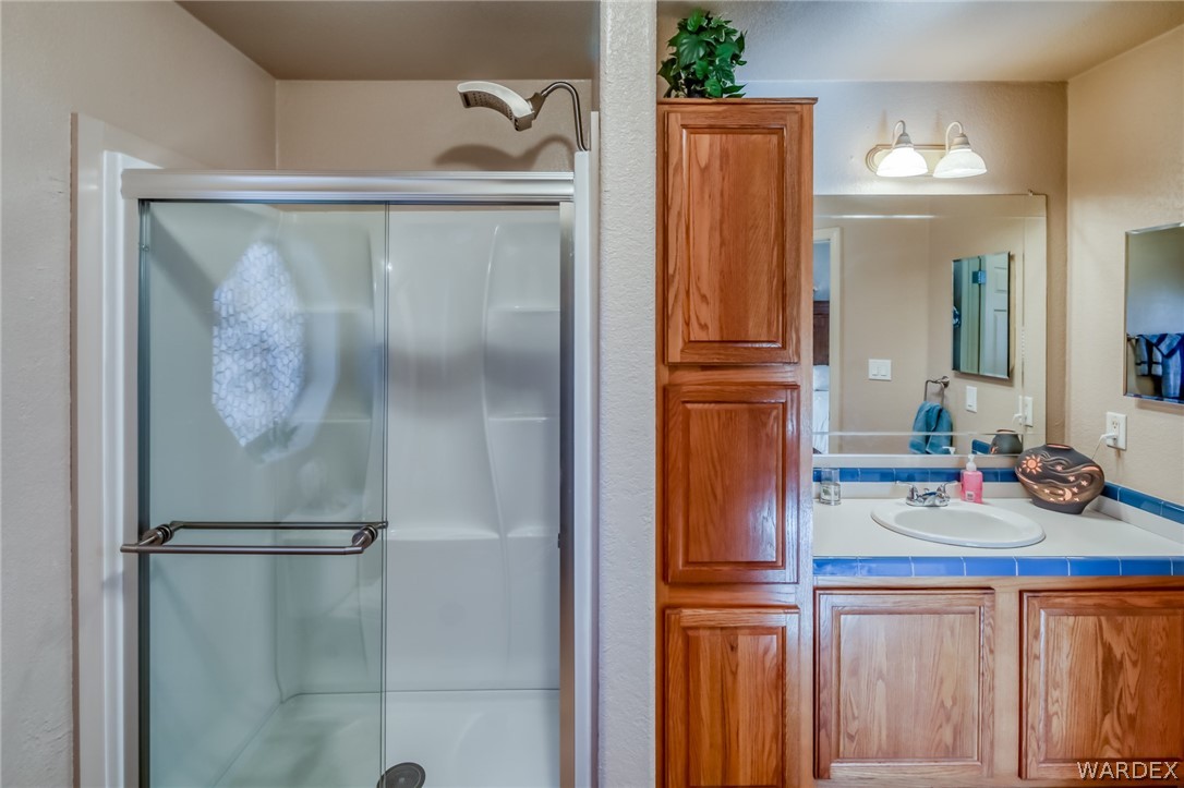 4150 Dragoon Road Golden Valley, AZ 86413 - Photo 26 of 49 a kitchen with a refrigerator and cabinets