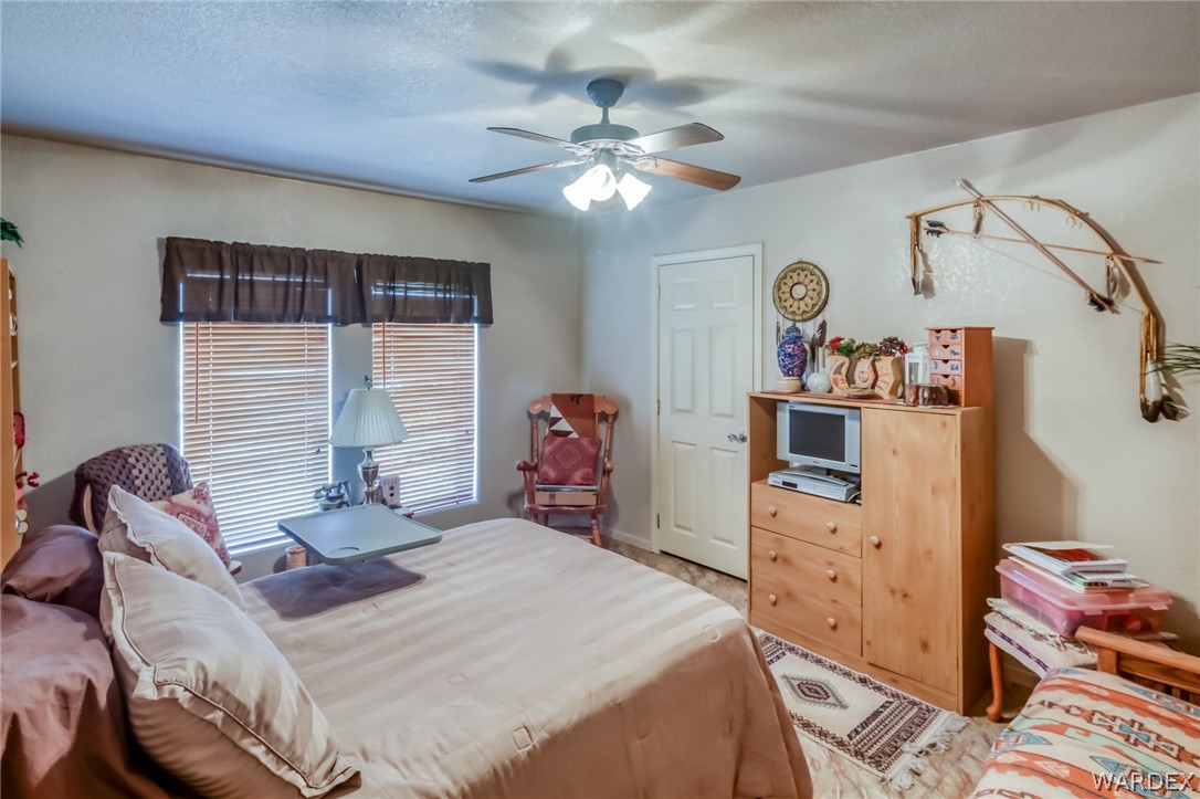 4150 Dragoon Road Golden Valley, AZ 86413 - Photo 31 of 49 a bedroom with a bed and a chandelier