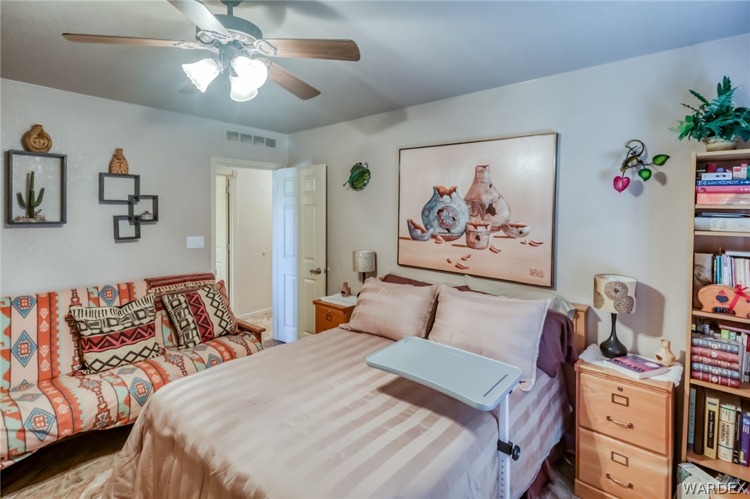 4150 Dragoon Road Golden Valley, AZ 86413 - Photo 32 of 49 a bedroom with a bed and wooden floor