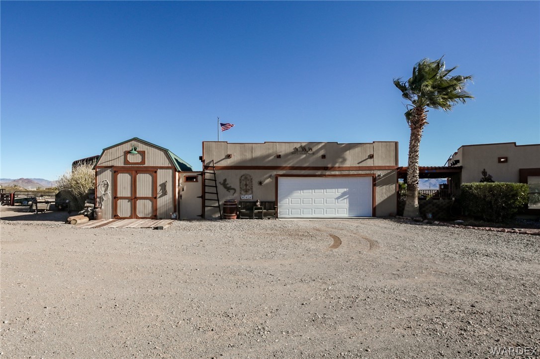 4150 Dragoon Road Golden Valley, AZ 86413 - Photo 5 of 49 a front view of a house with a yard and garage