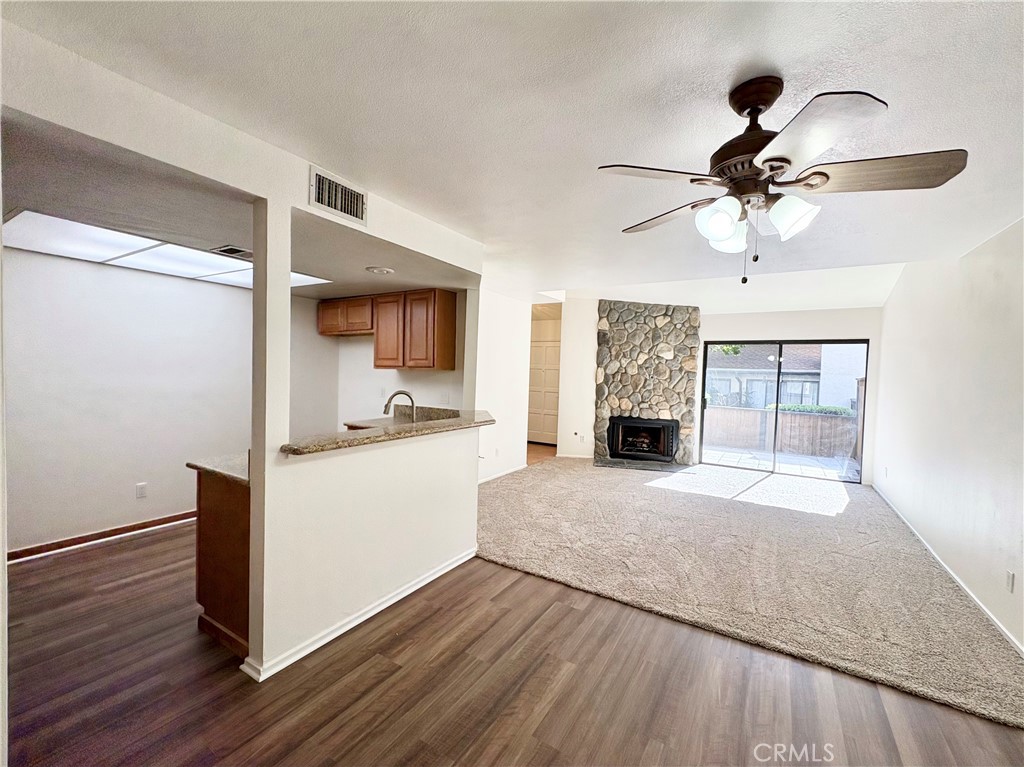 18223 Soledad Canyon Road, Unit 29 Canyon Country, CA 91387 - Photo 2 of 23 a living room with stainless steel appliances kitchen island granite countertop wooden floor and a ceiling fan