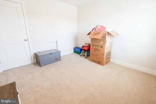 a large bed sitting in a bedroom next to a window