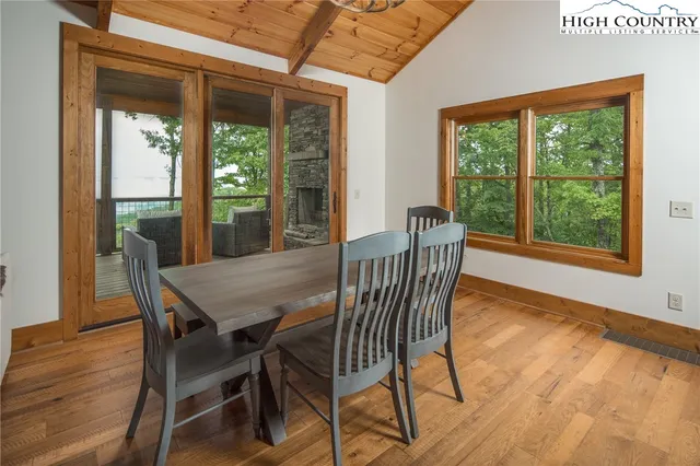 a dining room with furniture window and wooden floor