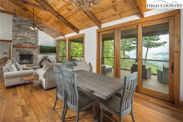 a view of a dining room with furniture large windows and wooden floor