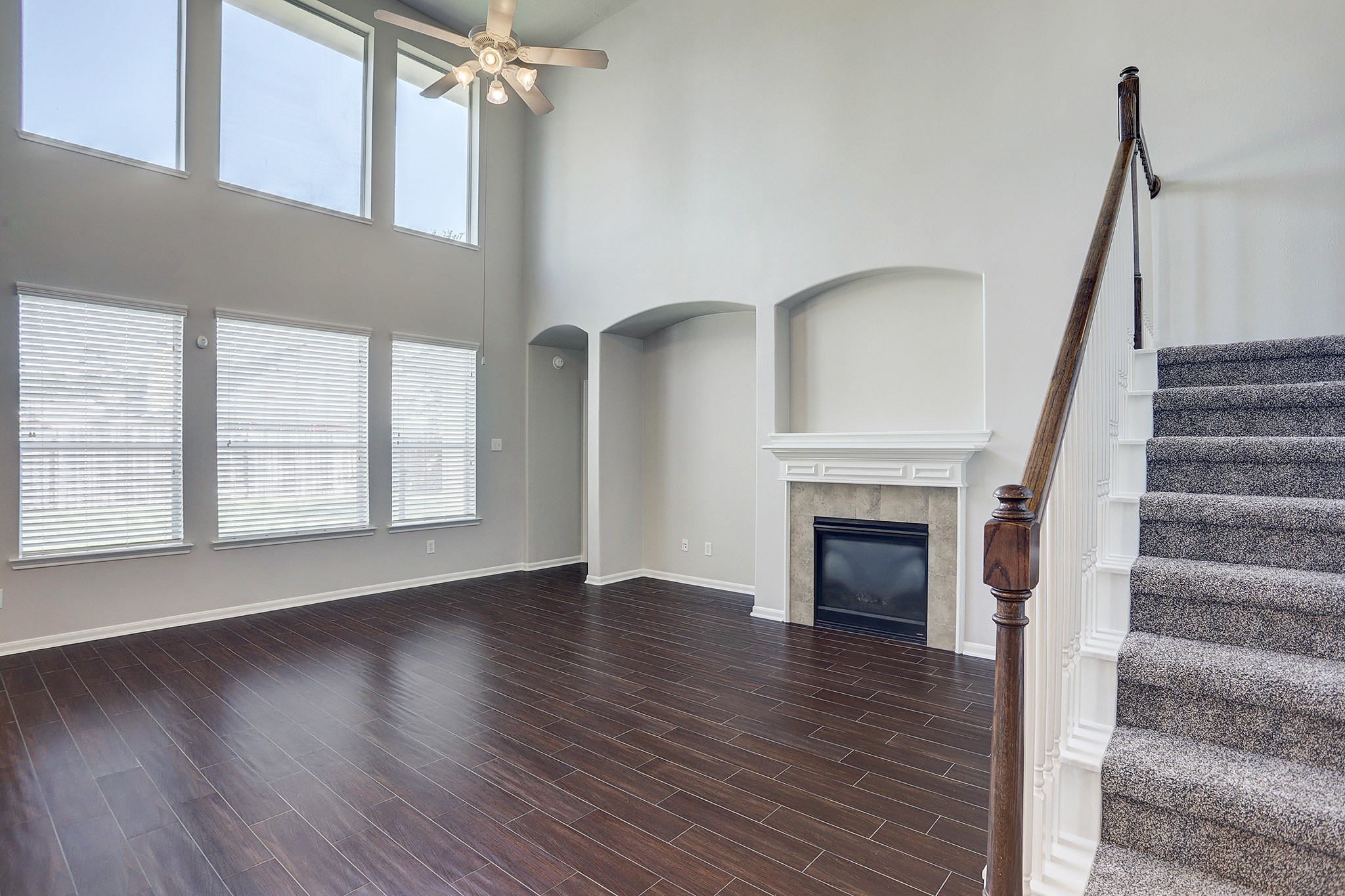 12331 Crescent Mountain Lane Humble, TX 77346 - Photo 12 of 34 a view of an empty room with wooden floor fireplace and windows