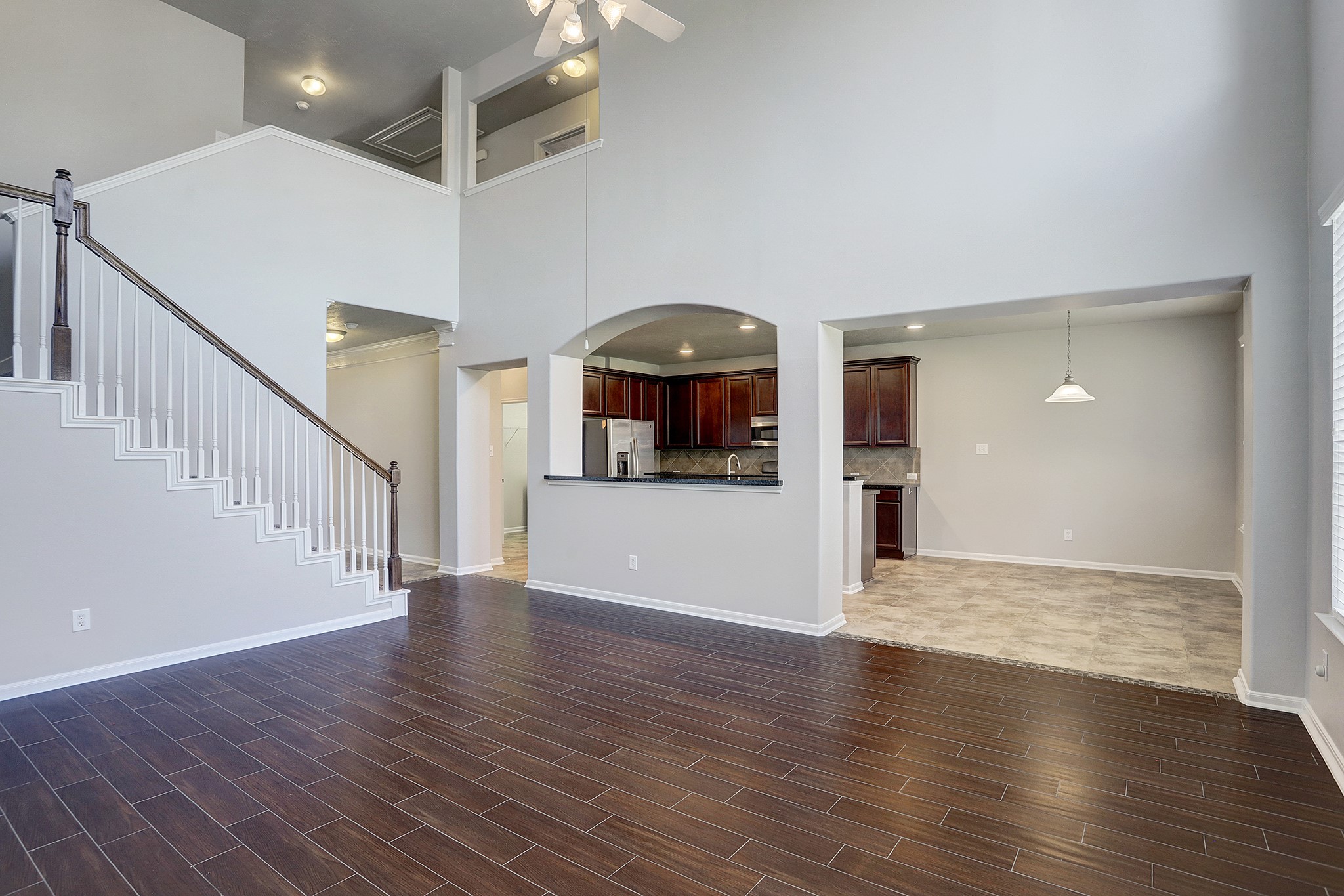 12331 Crescent Mountain Lane Humble, TX 77346 - Photo 14 of 34 a view of a hallway with wooden floor and a living room