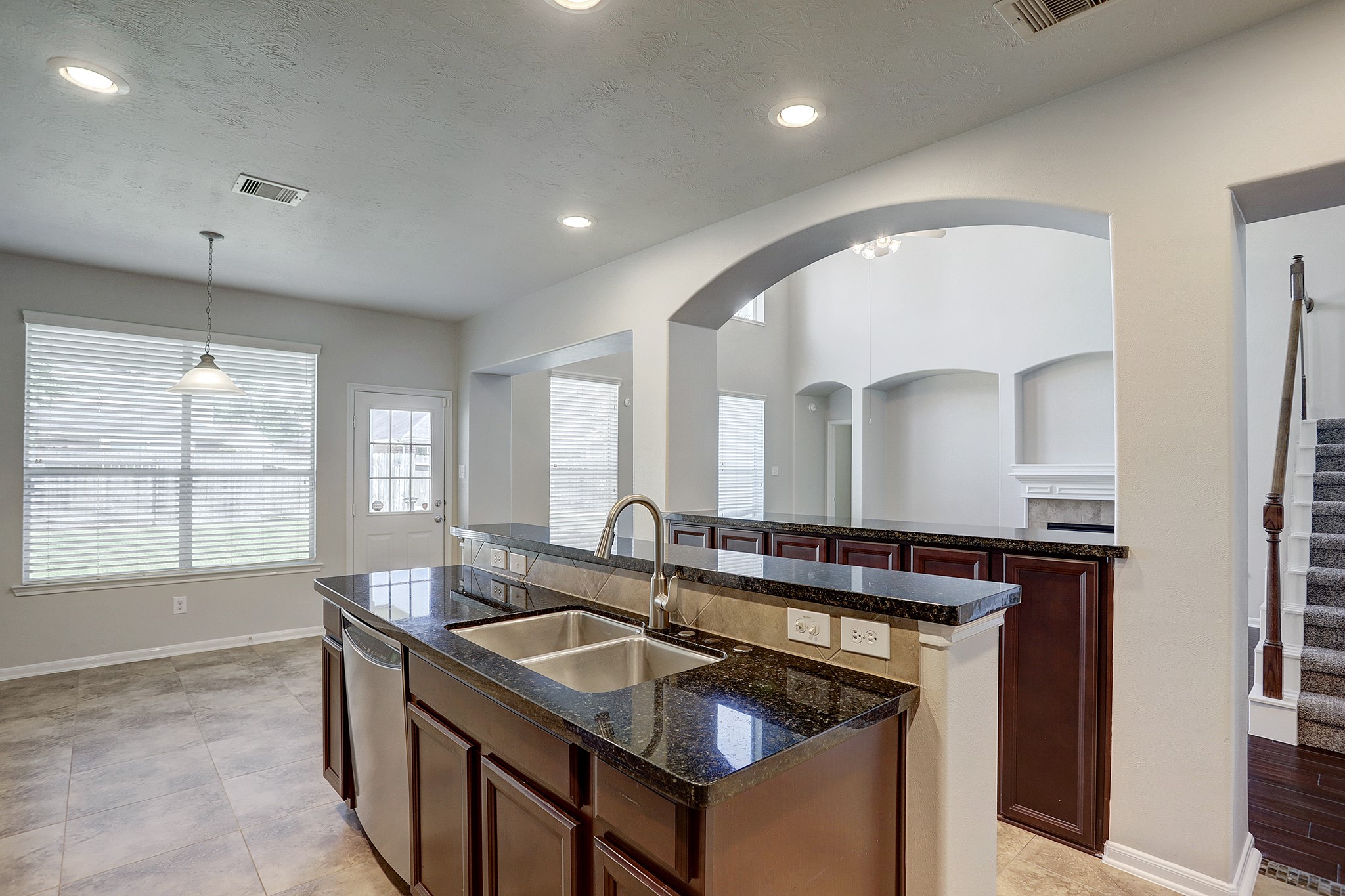12331 Crescent Mountain Lane Humble, TX 77346 - Photo 17 of 34 a kitchen that has a sink a stove and a table in it