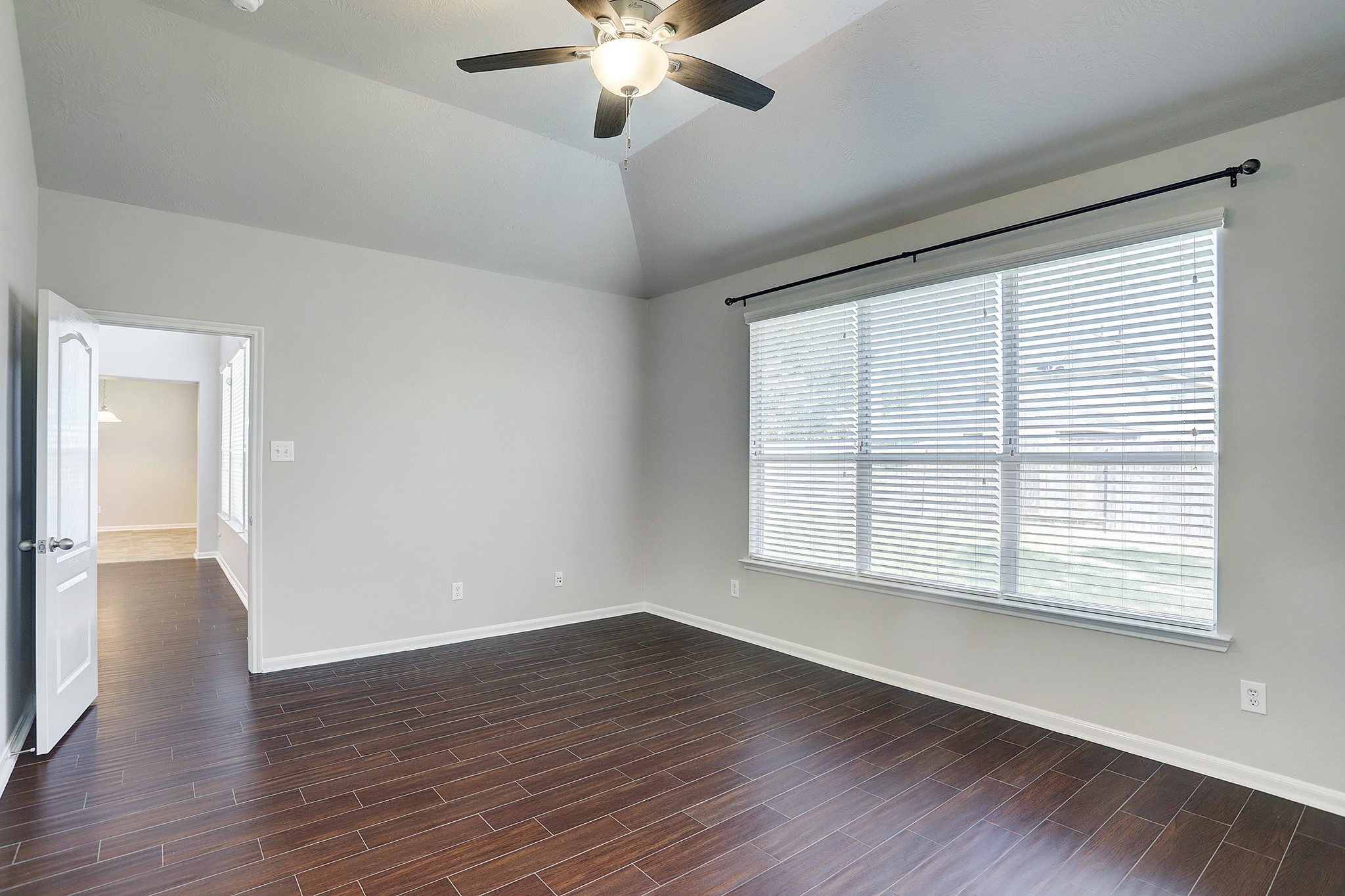 12331 Crescent Mountain Lane Humble, TX 77346 - Photo 19 of 34 a view of an empty room with wooden floor and a window