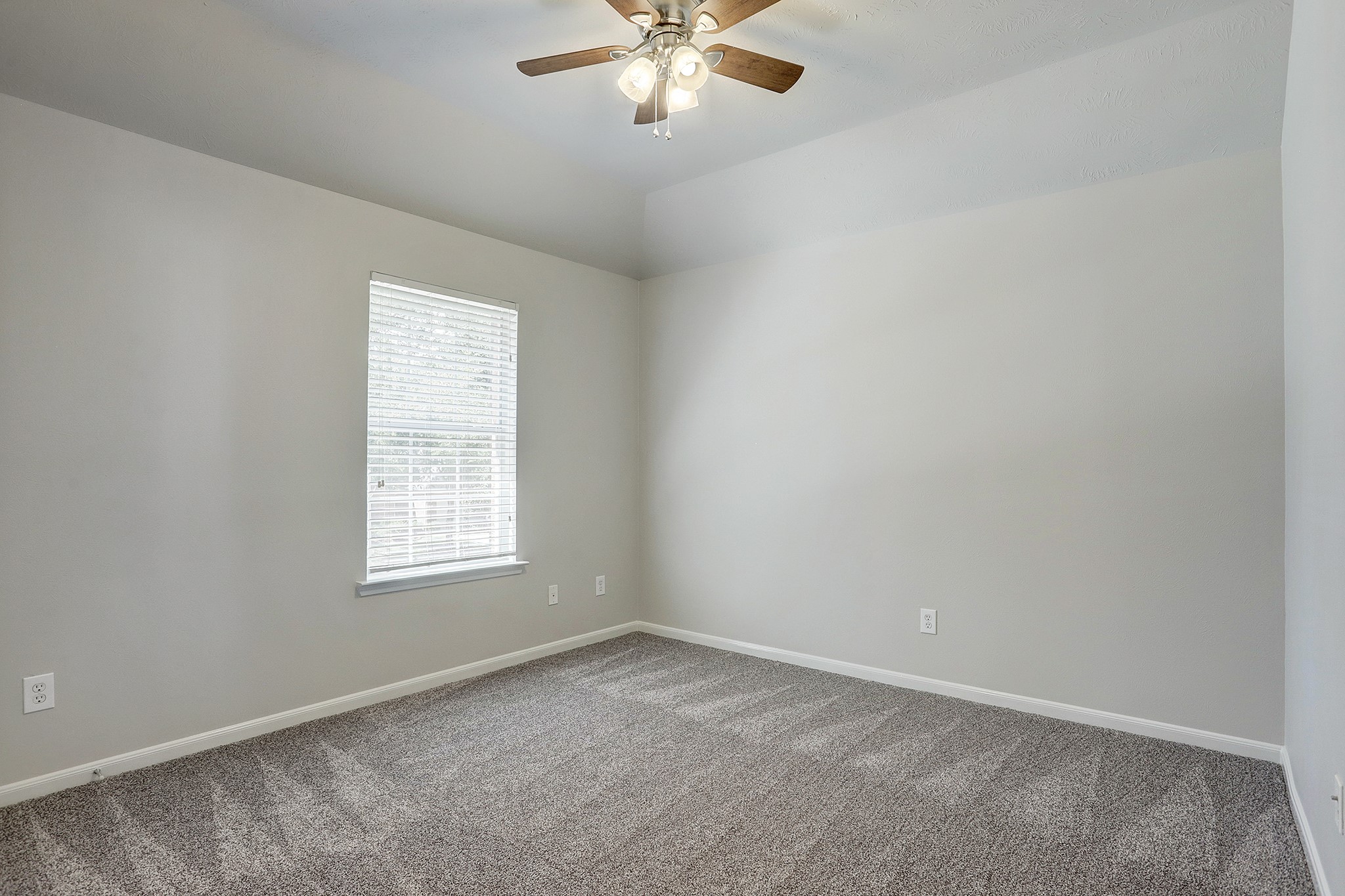 12331 Crescent Mountain Lane Humble, TX 77346 - Photo 27 of 34 an empty room with a window and a fan