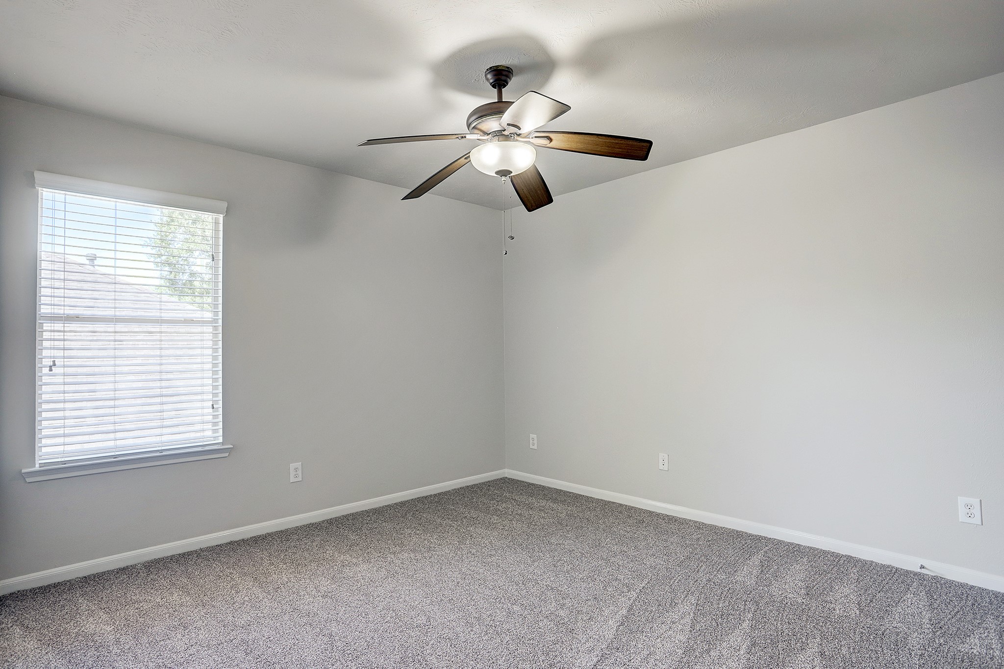 12331 Crescent Mountain Lane Humble, TX 77346 - Photo 31 of 34 an empty room with a window and a fan