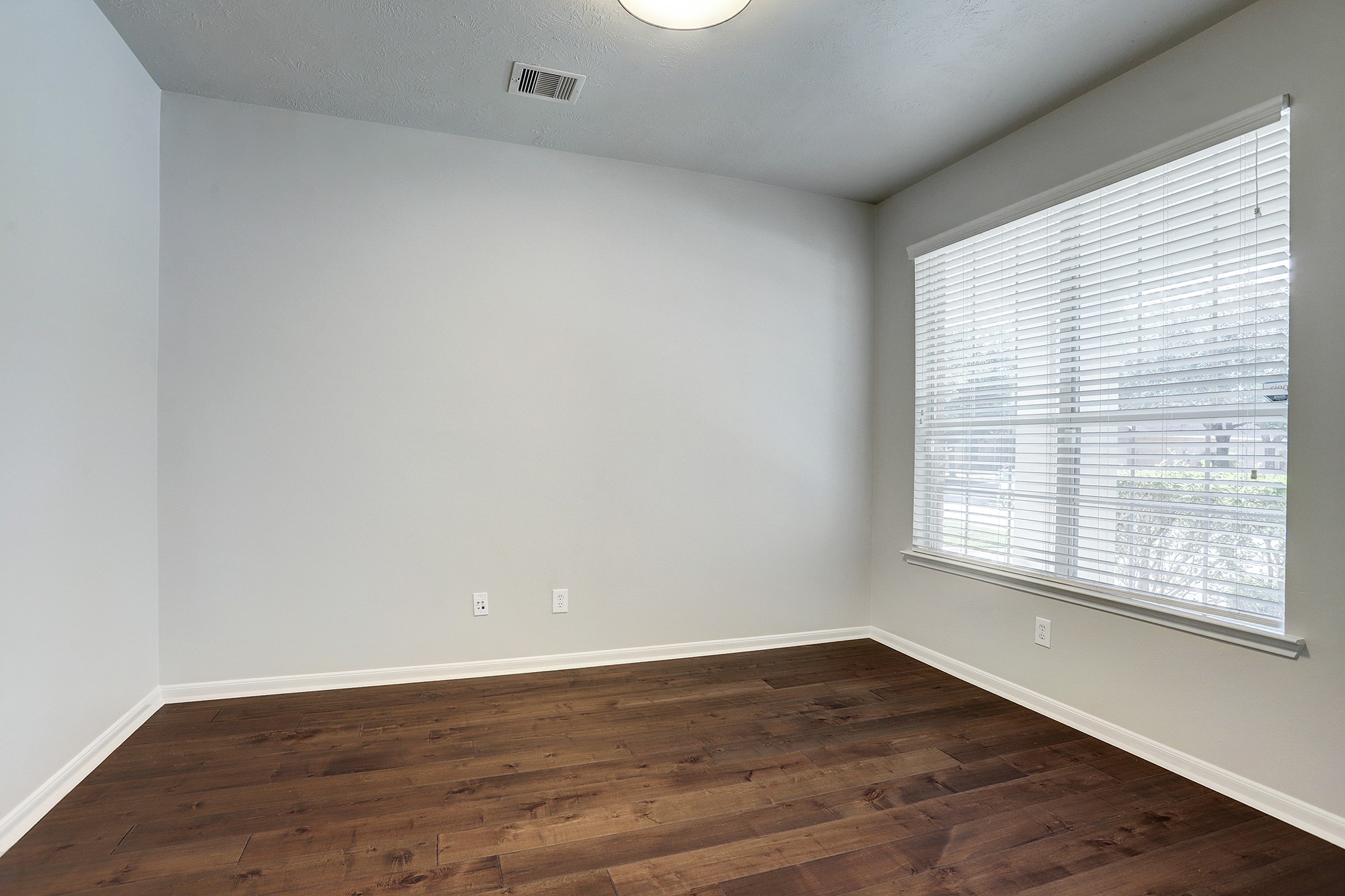 12331 Crescent Mountain Lane Humble, TX 77346 - Photo 9 of 34 wooden floor in an empty room with a window