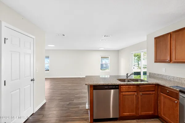 a kitchen with granite countertop a sink and cabinets