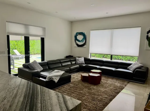 a living room with furniture a rug and a window