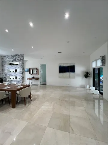 a living room with furniture a rug and a table