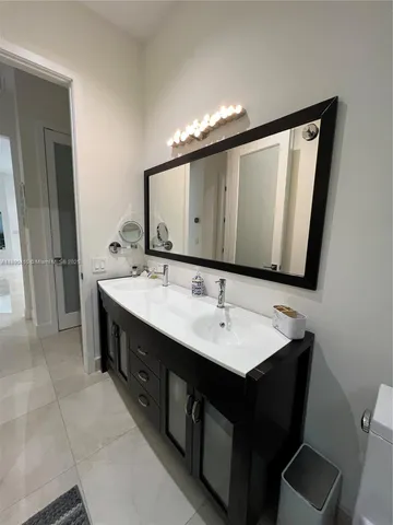 a bathroom with a double vanity sink and a mirror