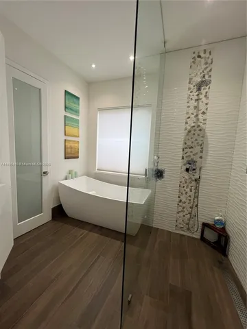 a spacious bathroom with a bathtub and a shower