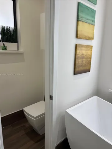 a bathroom with a toilet and a bathtub