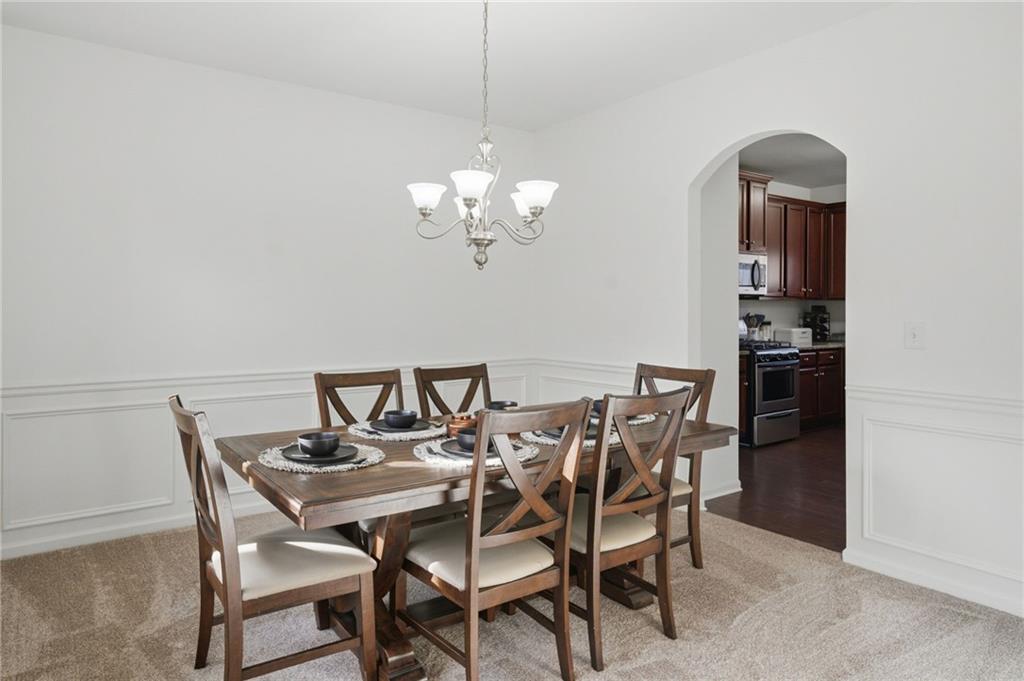 246 Manous Way Canton, GA 30115 - Photo 12 of 38 a view of a dining room with furniture and chandelier