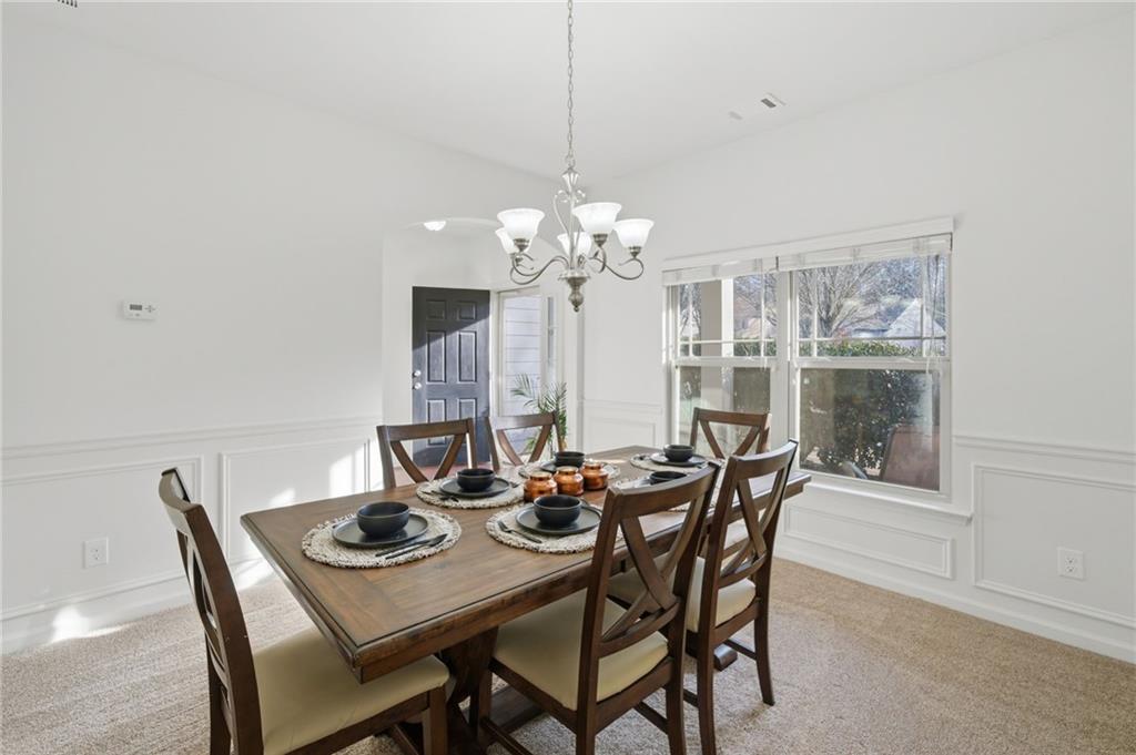246 Manous Way Canton, GA 30115 - Photo 13 of 38 a dining room with furniture a chandelier and window