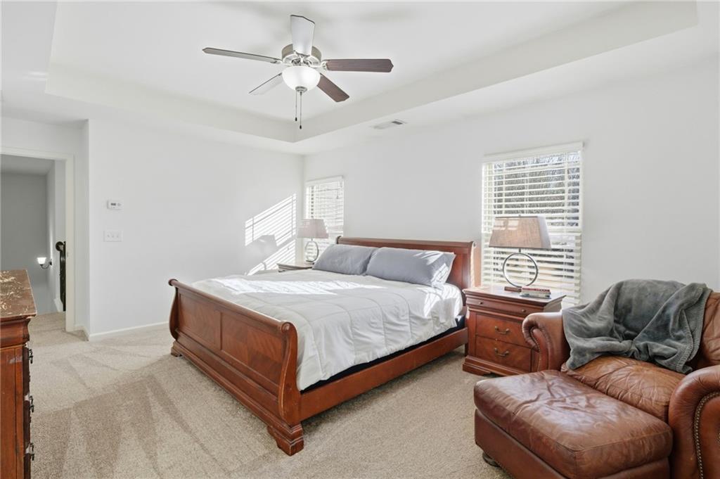 246 Manous Way Canton, GA 30115 - Photo 16 of 38 a bedroom with a bed couch chandelier and a window