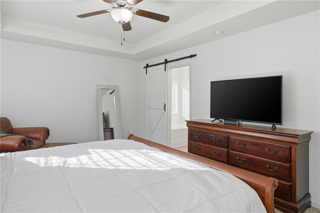 246 Manous Way Canton, GA 30115 - Photo 17 of 38 a bedroom with a bed and a flat screen tv
