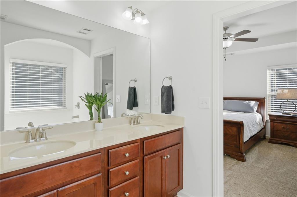 246 Manous Way Canton, GA 30115 - Photo 18 of 38 a en suite bathroom with a double vanity sink and a mirror
