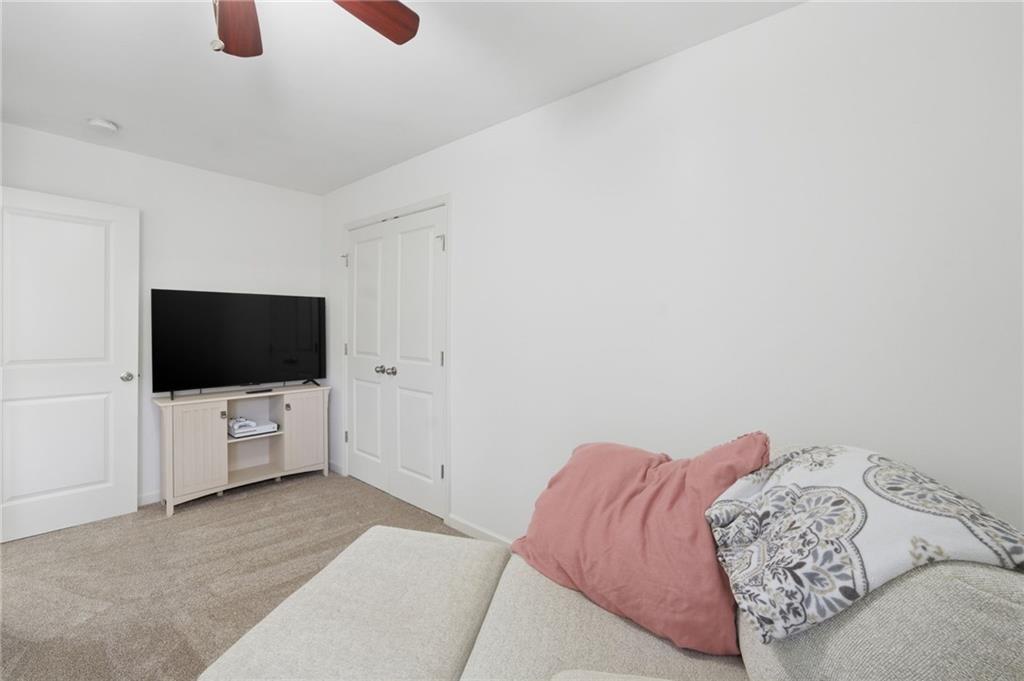 246 Manous Way Canton, GA 30115 - Photo 26 of 38 a living room with furniture and a flat screen tv
