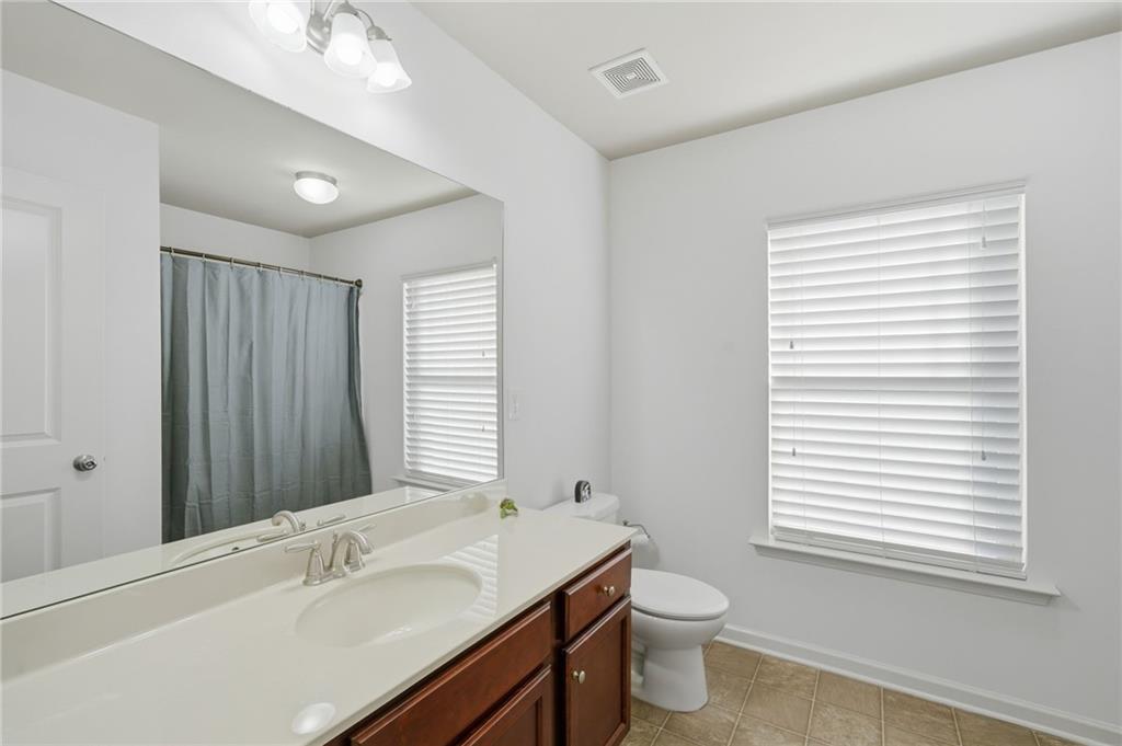 246 Manous Way Canton, GA 30115 - Photo 27 of 38 a bathroom with a double vanity sink toilet and a mirror
