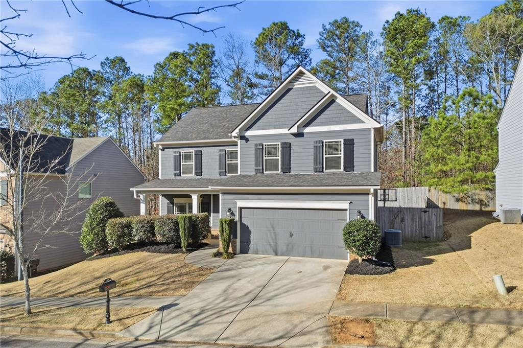 246 Manous Way Canton, GA 30115 - Photo 29 of 38 a front view of a house with a yard and trees