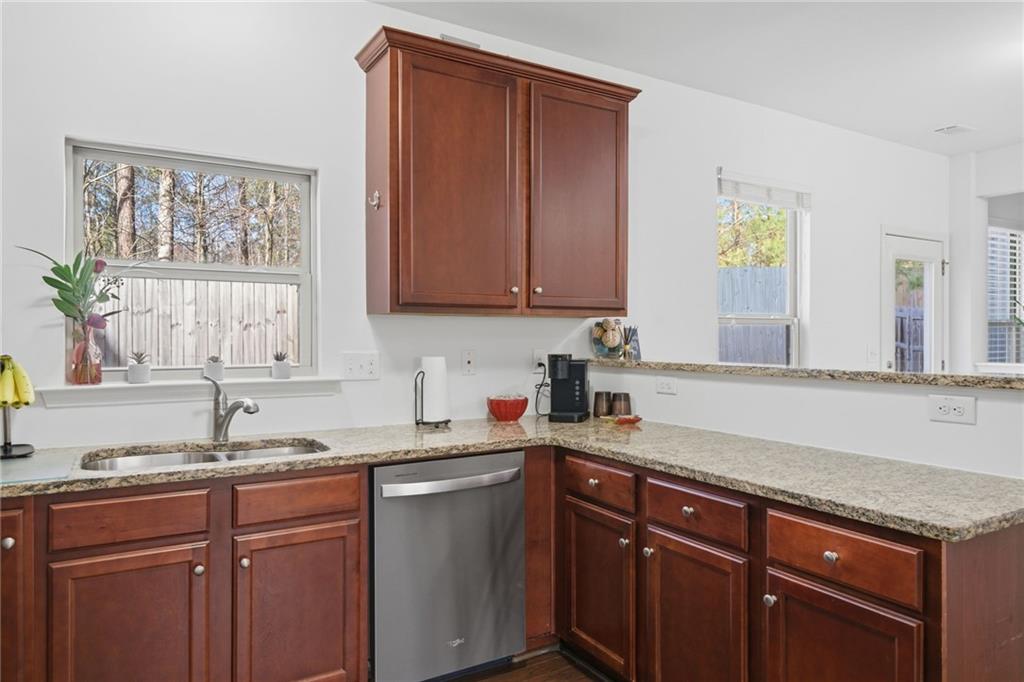 246 Manous Way Canton, GA 30115 - Photo 4 of 38 a kitchen with granite countertop a sink cabinets and window