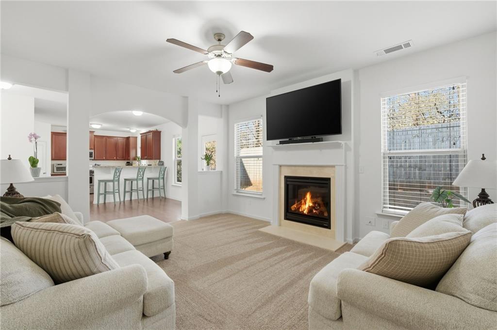 246 Manous Way Canton, GA 30115 - Photo 6 of 38 a living room with furniture a flat screen tv and a fireplace