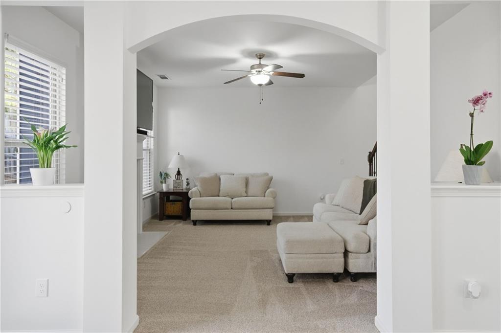 246 Manous Way Canton, GA 30115 - Photo 7 of 38 a living room with furniture and a chandelier
