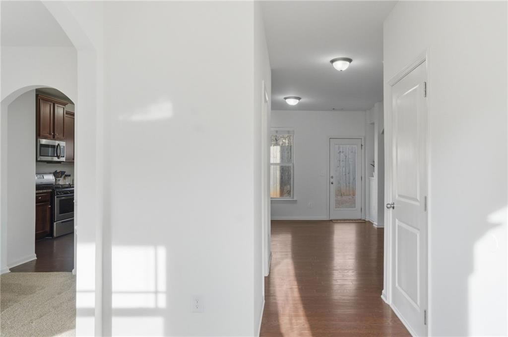 246 Manous Way Canton, GA 30115 - Photo 10 of 38 a view of a hallway with wooden floor near a living room