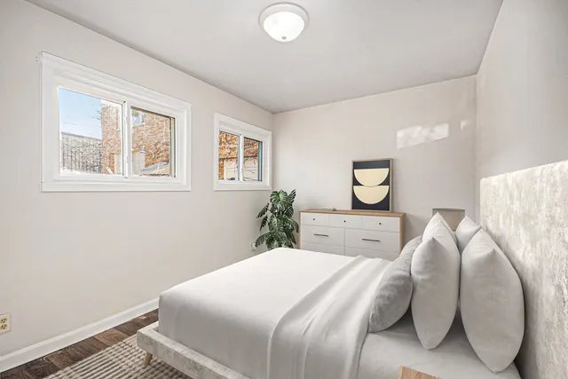 a bedroom with a bed and a painting on the wall