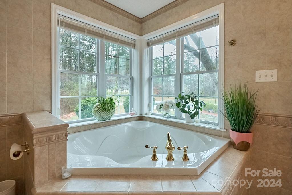 1106 Landrum Road Columbus, NC 28722 - Photo 26 of 41 a white bath tub sitting in front of a window