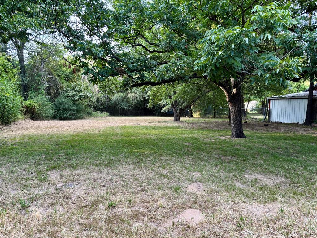 3024 Bonham Street Paris, TX 75460 - Photo 11 of 13 a view of outdoor space with deck and yard
