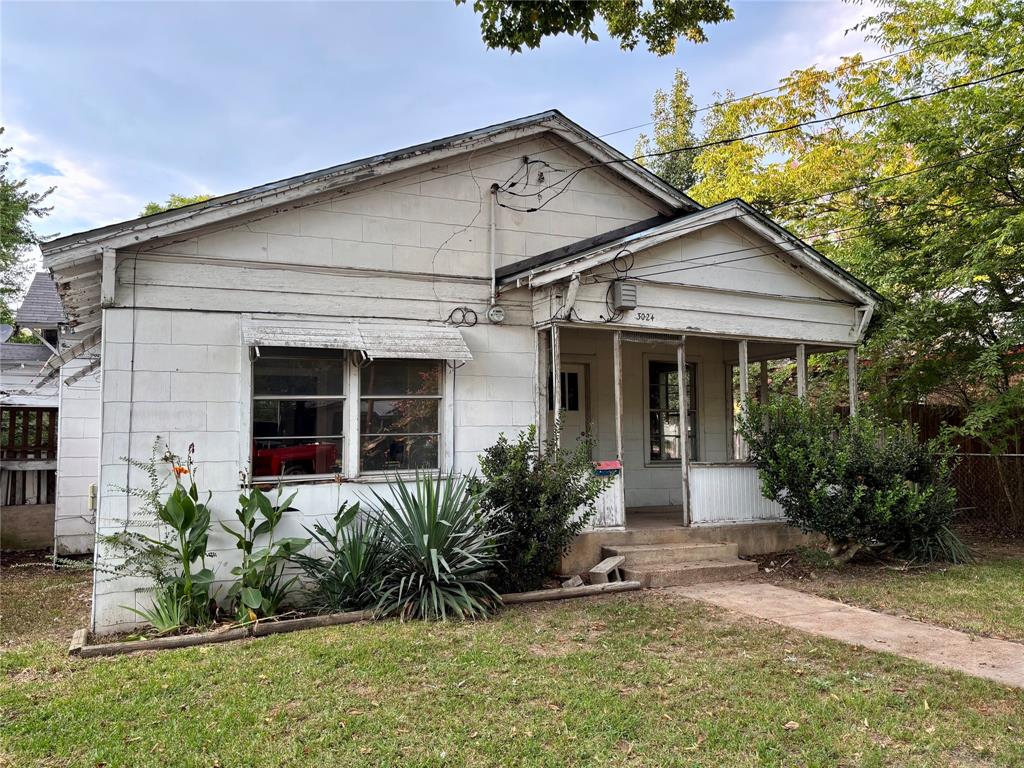 3024 Bonham Street Paris, TX 75460 - Photo 12 of 13 a front view of a house with a yard and potted plants