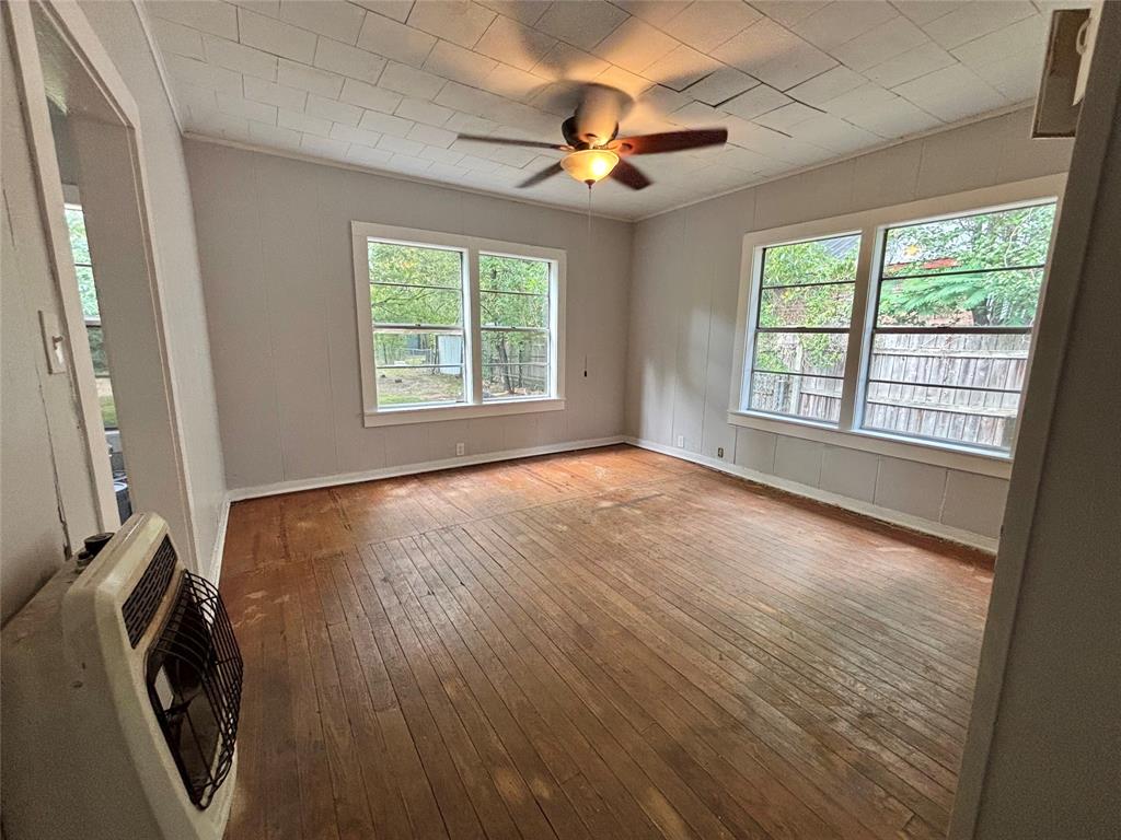 3024 Bonham Street Paris, TX 75460 - Photo 9 of 13 a view of an empty room with a window and wooden floor
