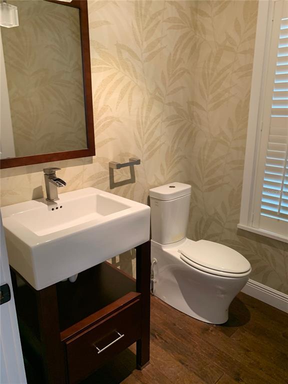 910 Pawstand Road Celebration, FL 34747 - Photo 13 of 33 a bathroom with a sink toilet and mirror