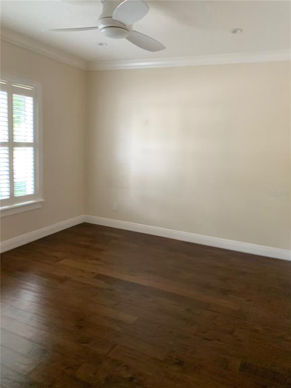 910 Pawstand Road Celebration, FL 34747 - Photo 14 of 33 an empty room with wooden floor and windows